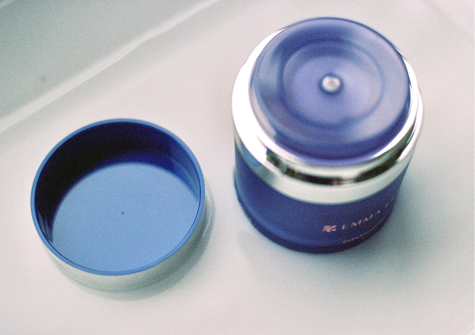 An open refillable bottle of an Emma Lewisham product