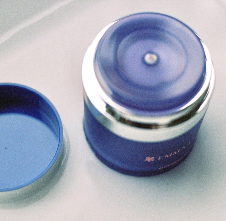An open refillable bottle of an Emma Lewisham product