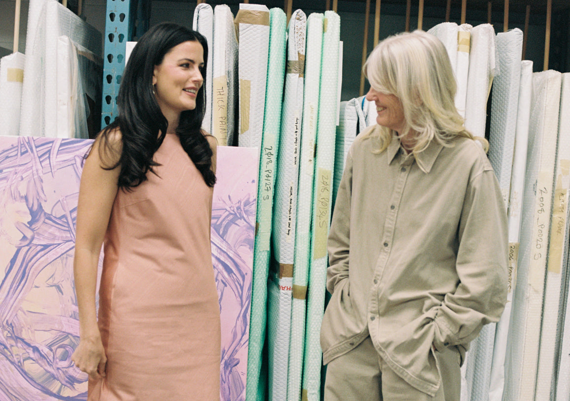 Emma Lewisham and Judly Millar standing in front of a display of fabric swatches.
