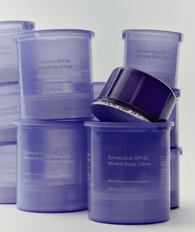 Stack of Suncaceutical SPF 50 Mineral Body Crème containers on a white background